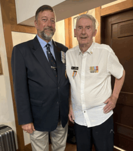 Halifax. Bruce Belliveau, President of NAC NS, announces the grant for the Korean War veteran Tom Estabrooks to be shared with his fellow veteran Graham McBride